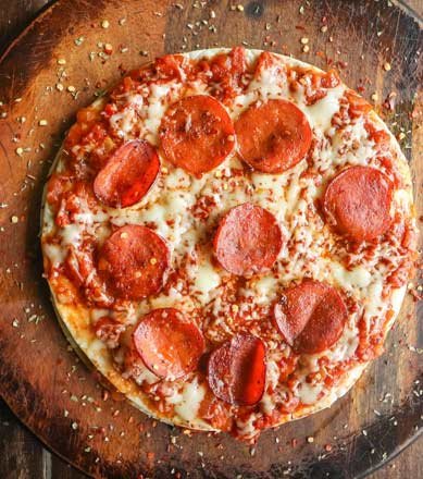 Pepperoni pizza on a wooden board